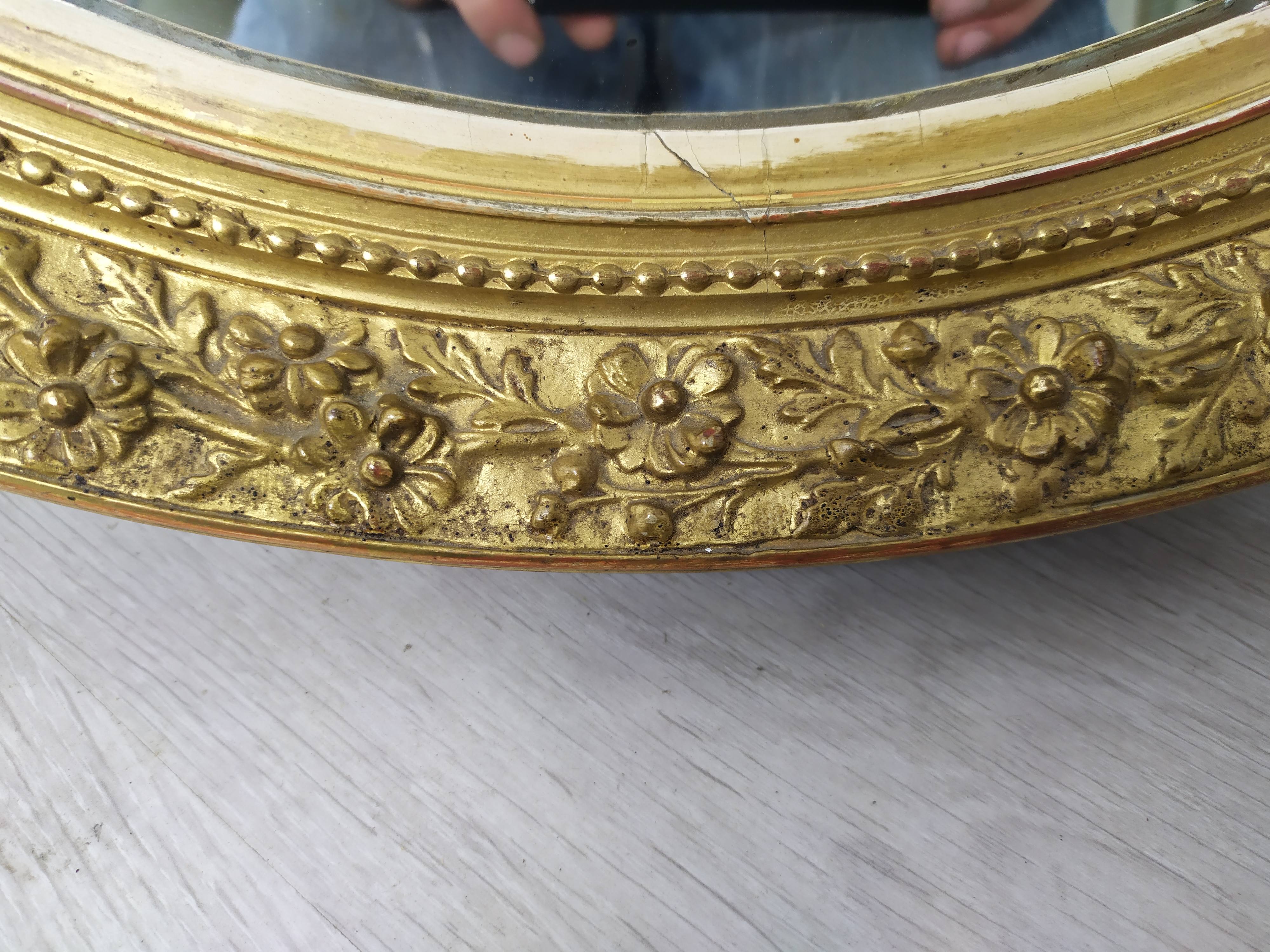 Golden oval mirror