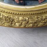 Golden oval mirror