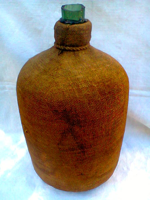 Demijohn dressed in burlap and padded cork