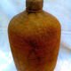 Demijohn dressed in burlap and padded cork