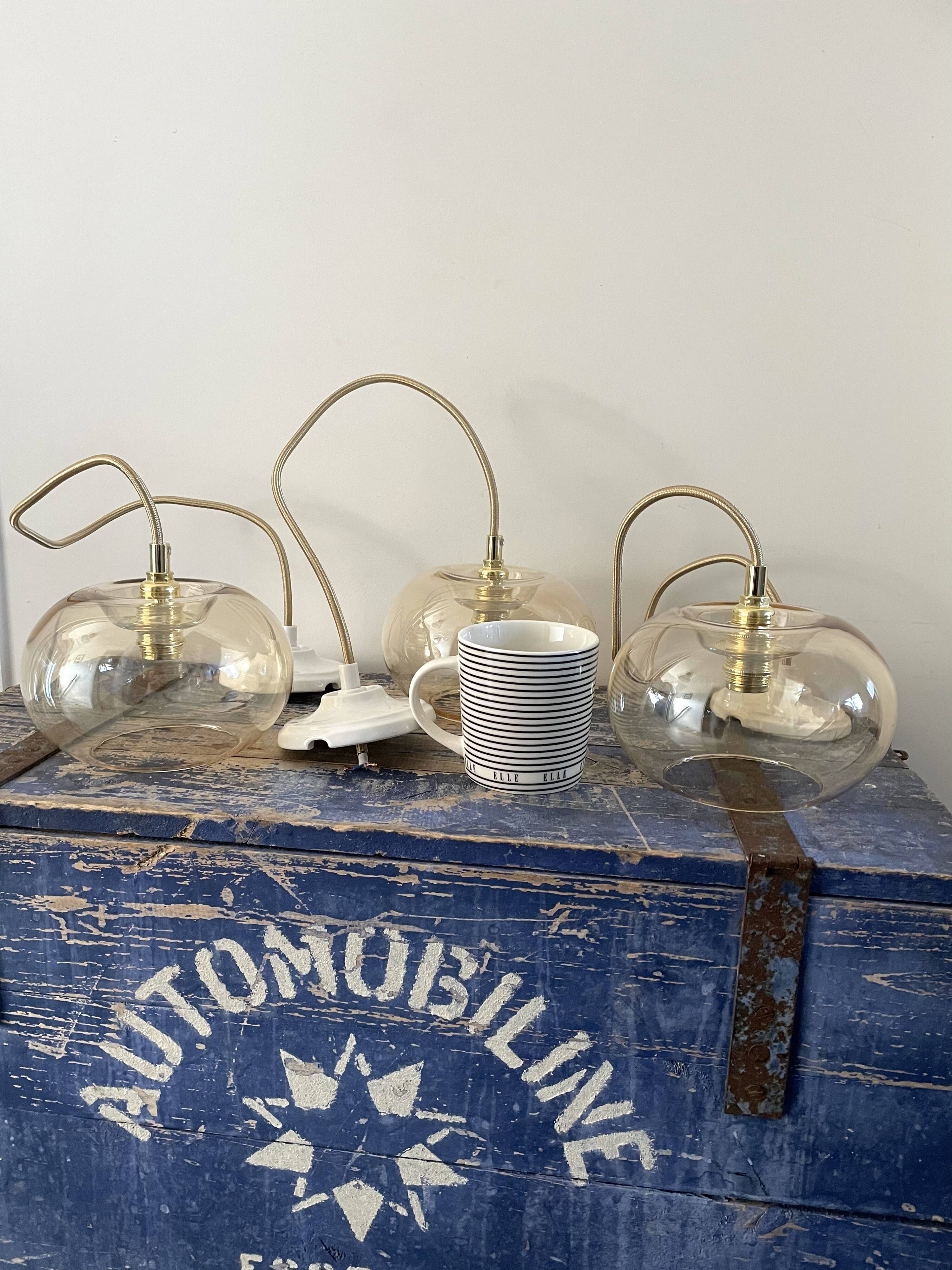 Set of three new electrified golden glass pendant lamps