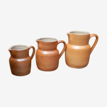 Trio of pitchers, old stoneware milk pots, country style