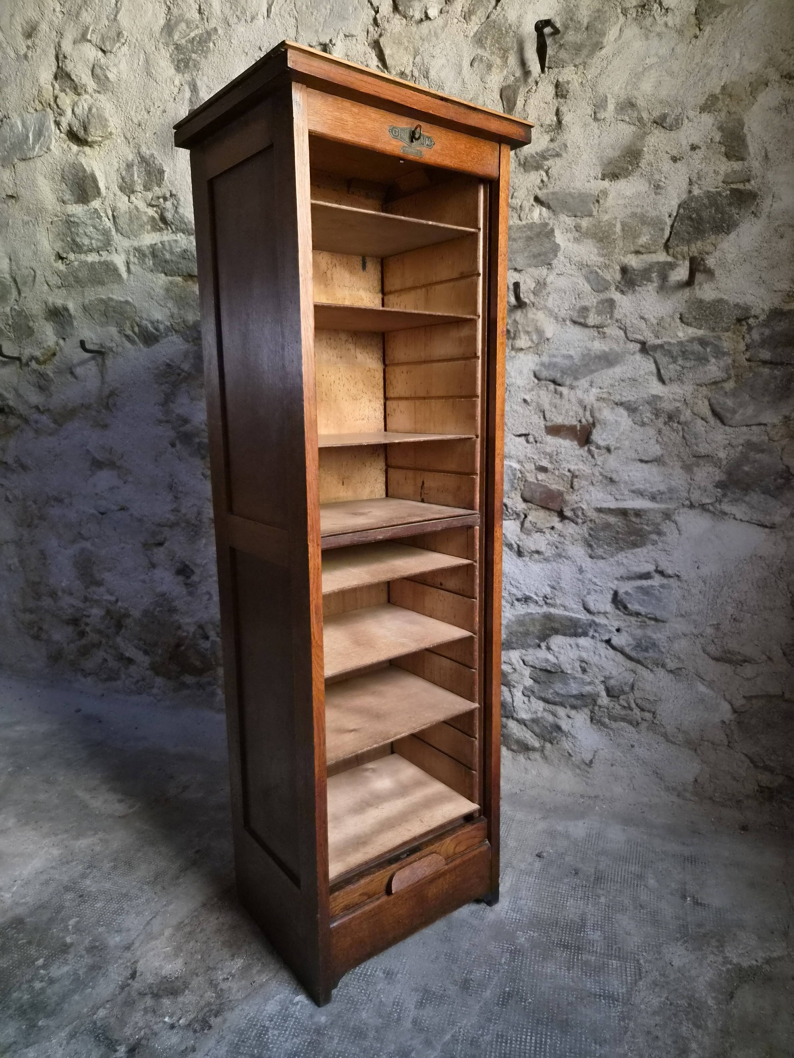 French antique wardrobe with curtain in oak, circa 1920–1930.