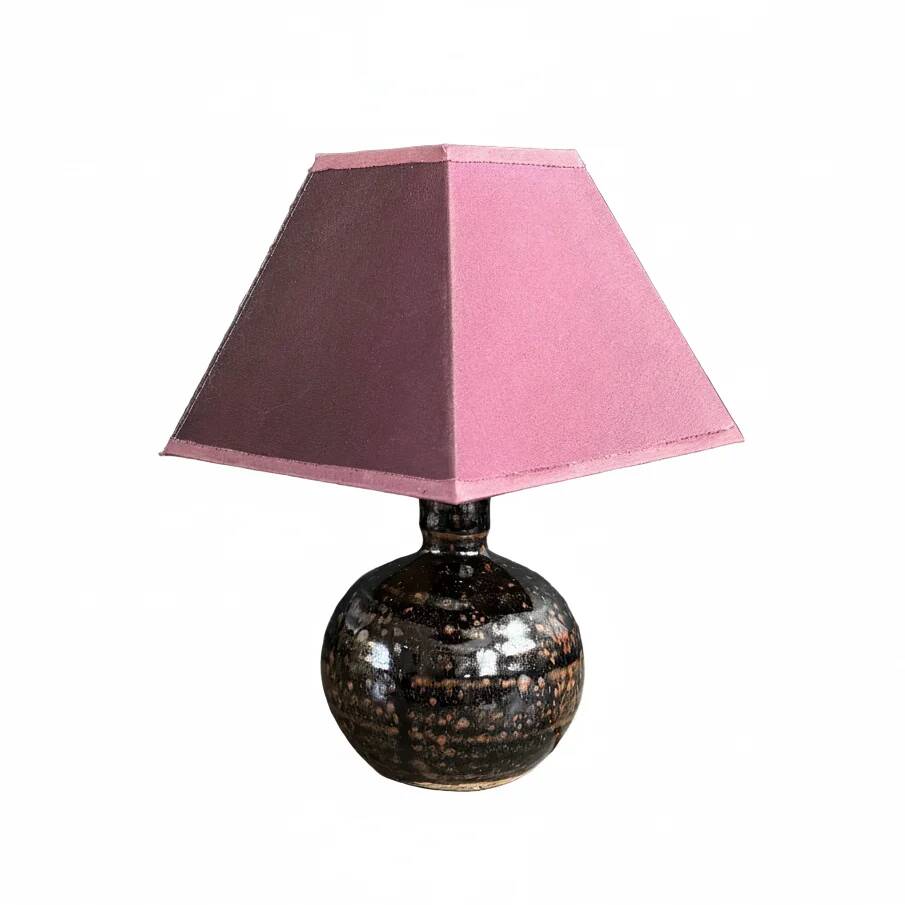 Ceramic floor lamp with a pyramidal shade and square base.