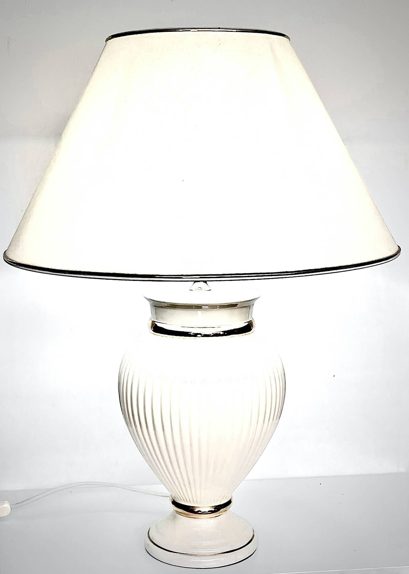 Vintage white ceramic table lamp, ribbed body and conical shade.