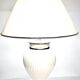 Vintage white ceramic table lamp, ribbed body and conical shade.