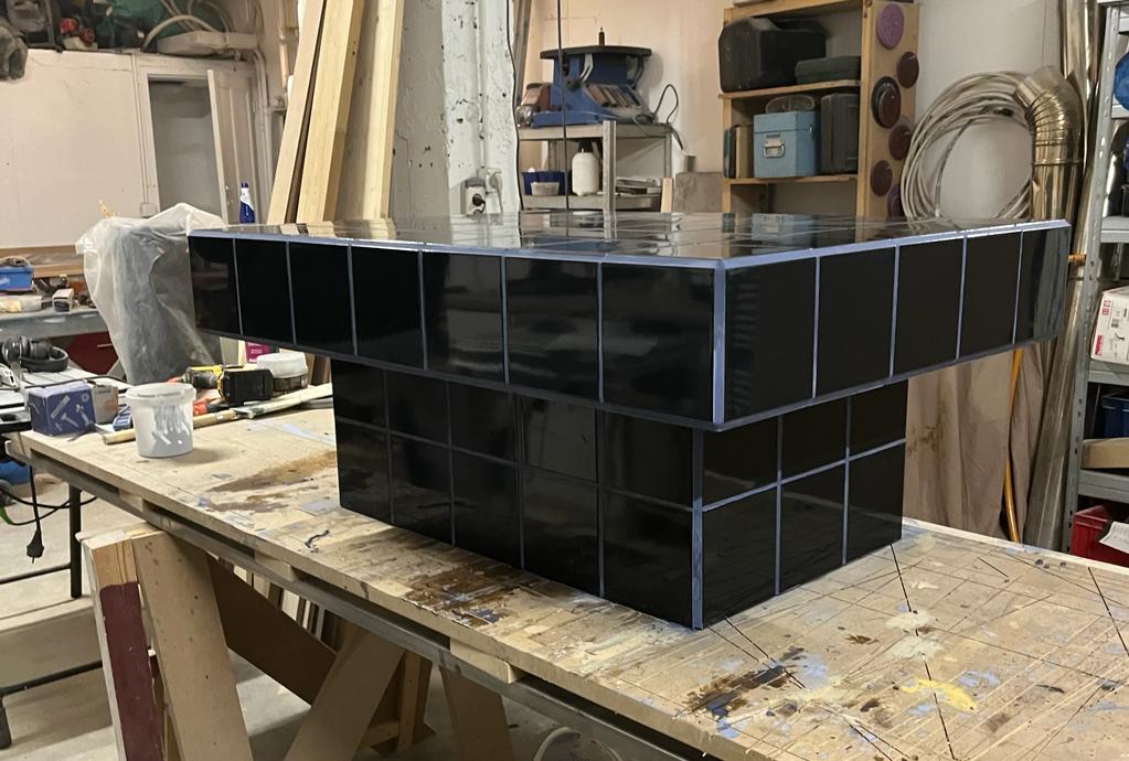 Black tiled coffee table and midnight blue grout