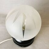 Small black wooden table lamp with frosted glass globe