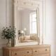 Miroir ancien biseauté, cadre en bois et stuc patiné gris perle.