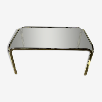 Coffee table in smoked glass and brass dating from the early 1970s.