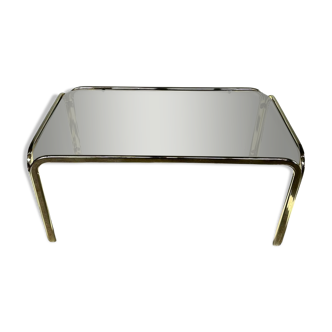 Coffee table in smoked glass and brass dating from the early 1970s.