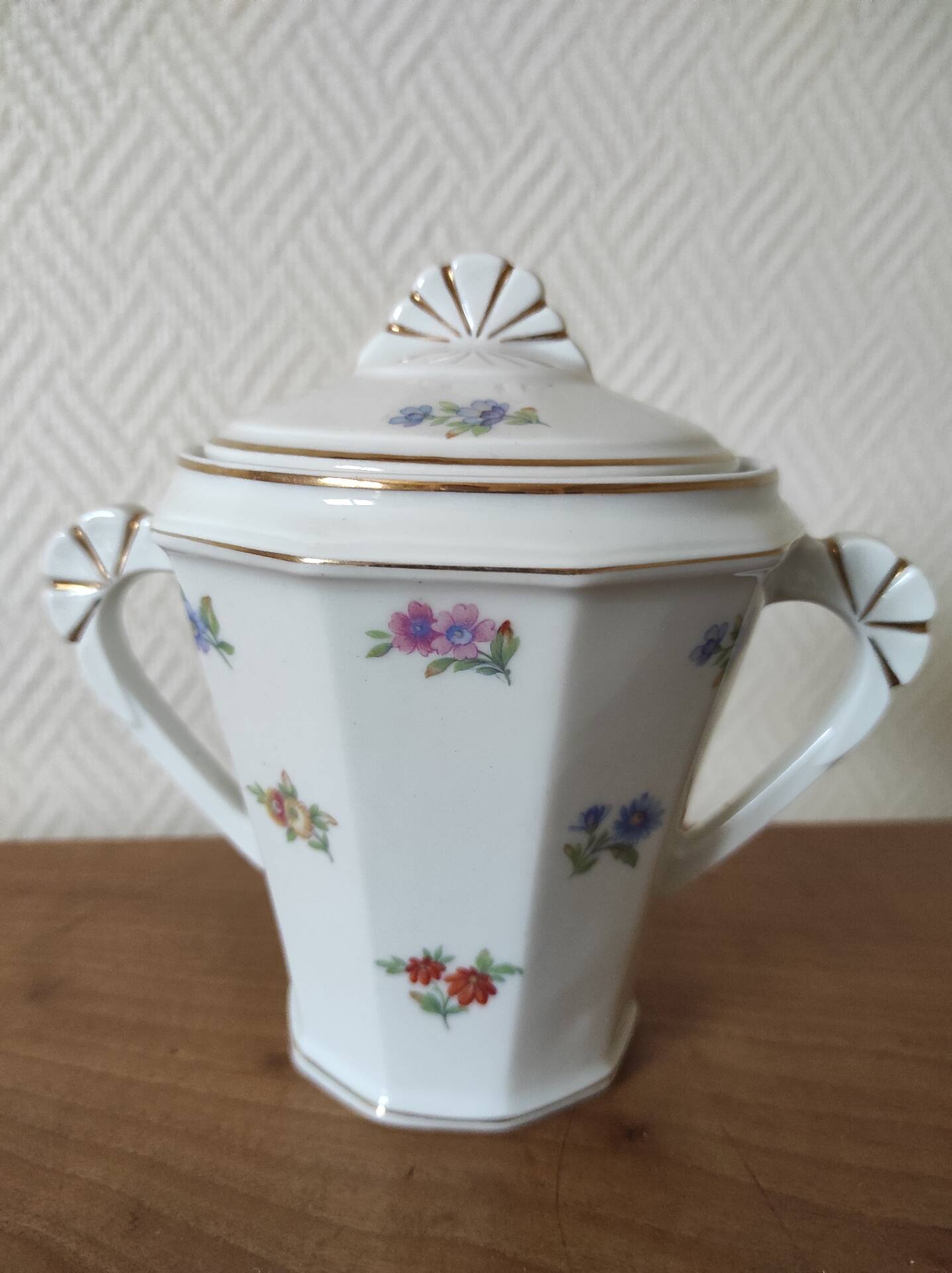 Antique porcelain sugar bowl with a decagonal base.
