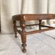 Low wooden stool with caning, footrest.