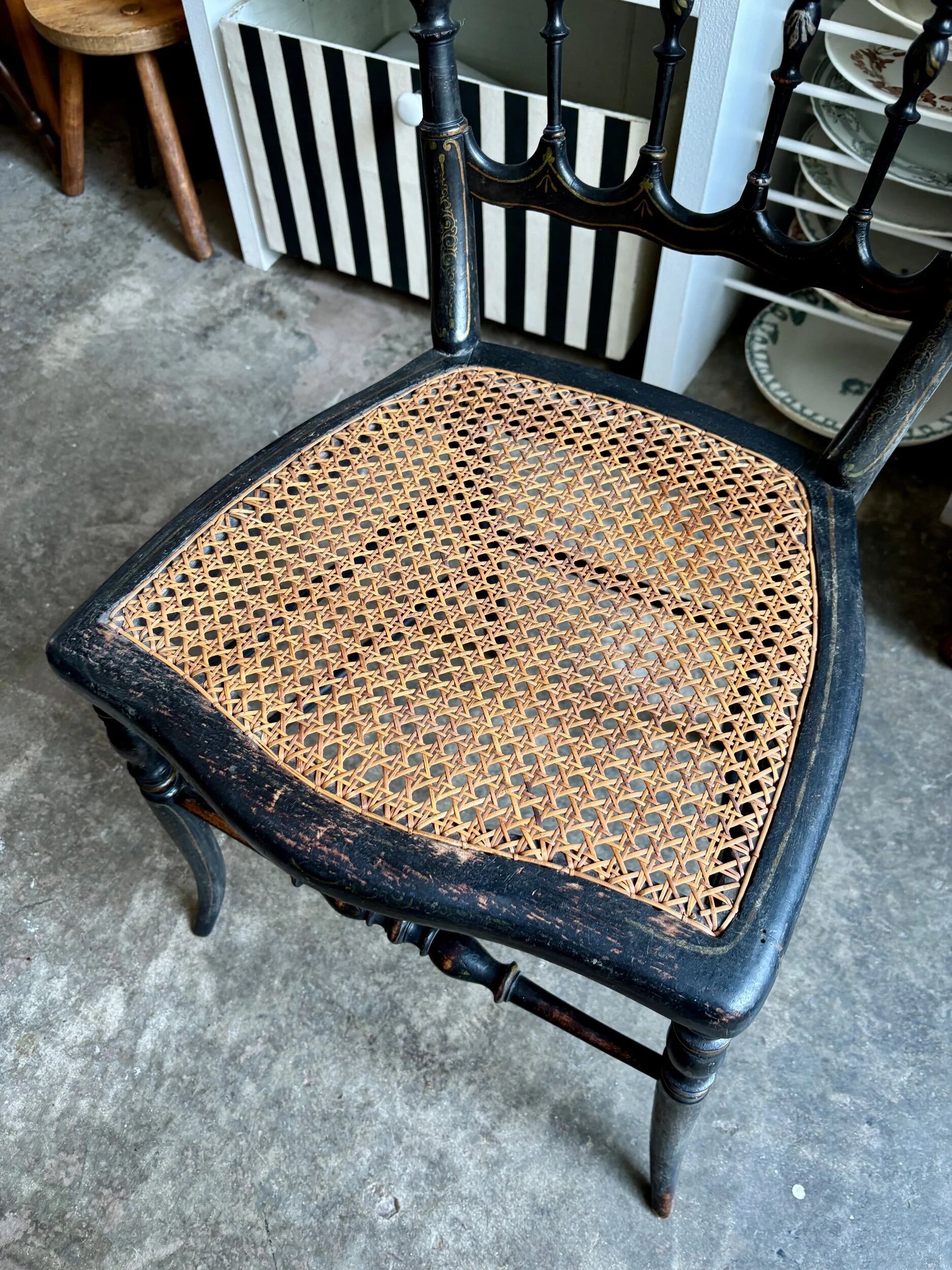 Napoleon III chair in black and gold wood with caning.