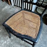 Napoleon III chair in black and gold wood with caning.