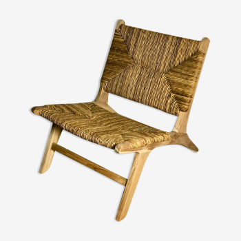 Low armchair in raw teak with seat and mulched backrest