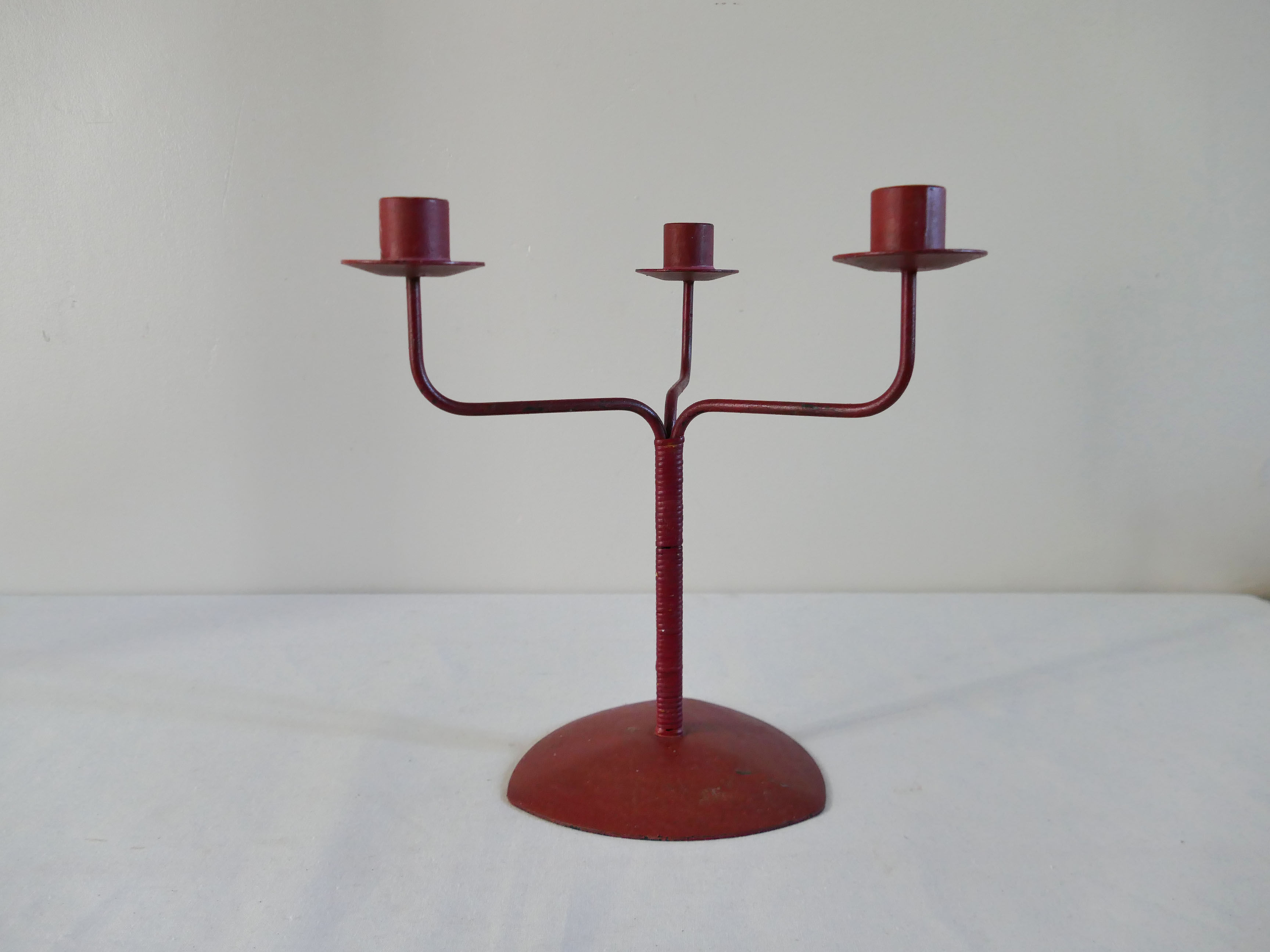 Red metal chandelier for three candles
