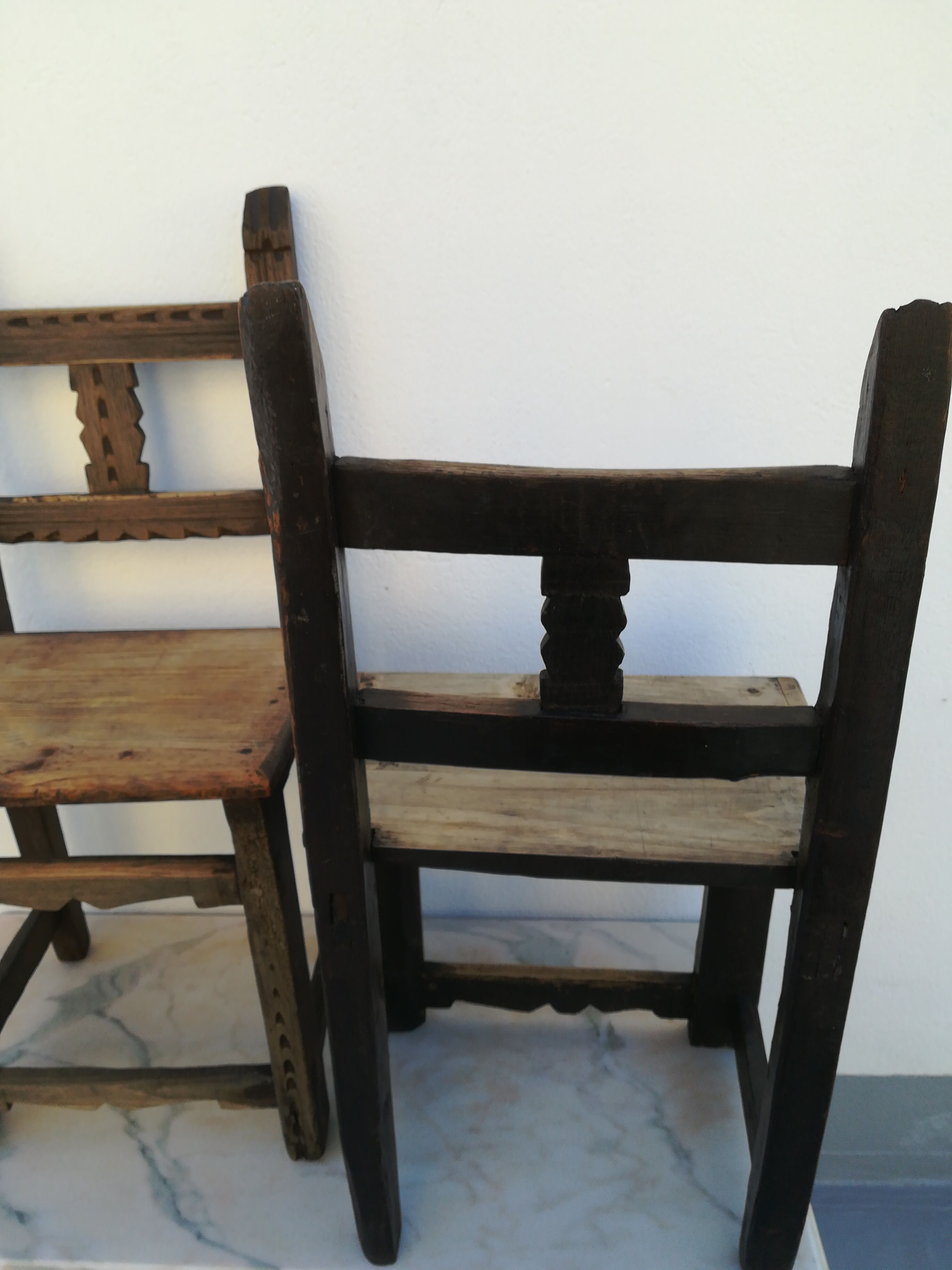 Pair of ethnic crude wooden chairs