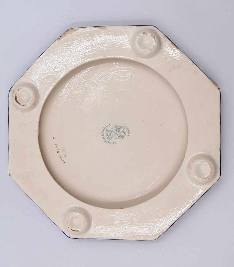 A flat bottom and two enamel bottle bottoms of Longwy