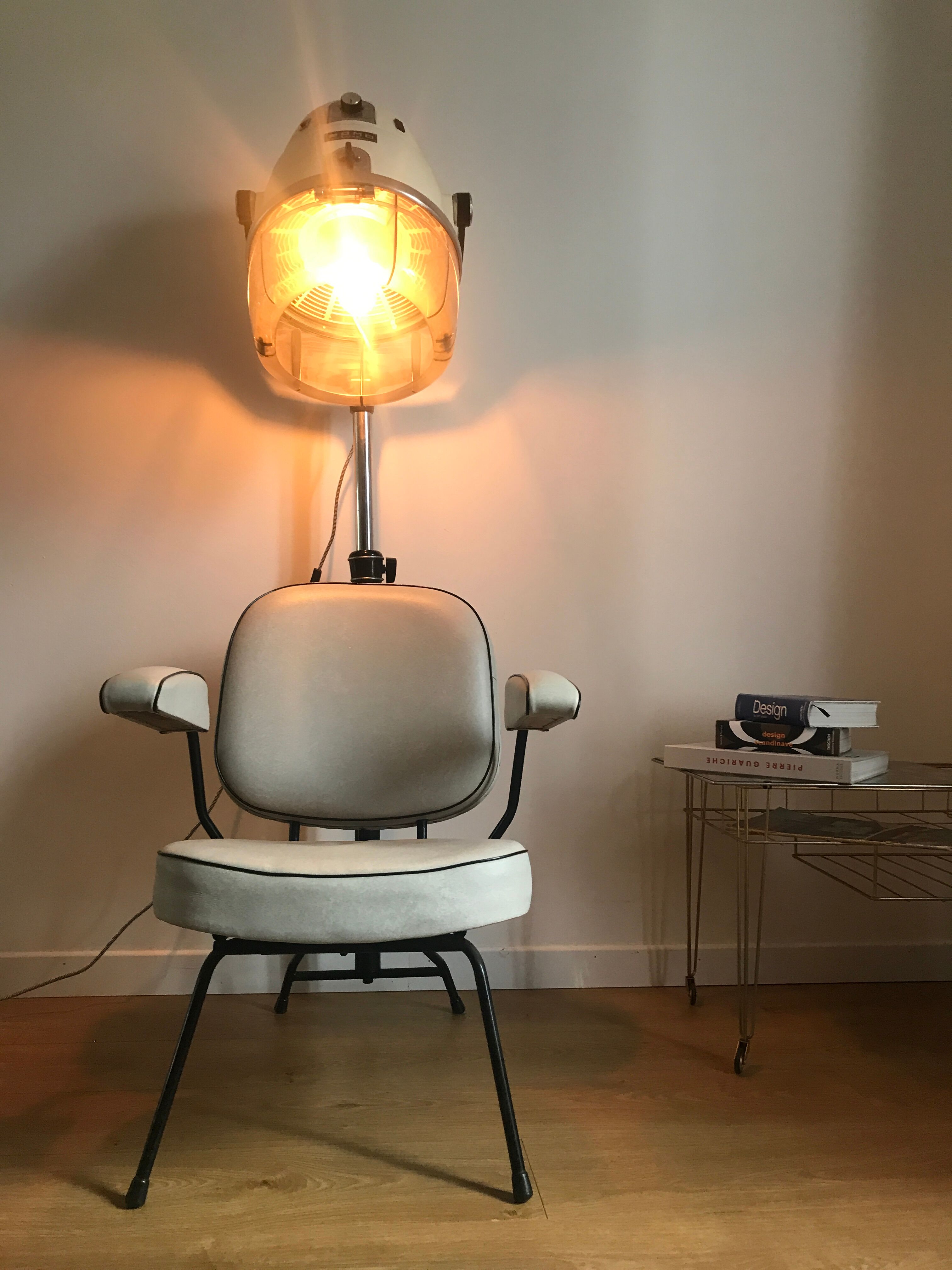 Vintage hairdresser's armchair with helmet transformed into a lamp