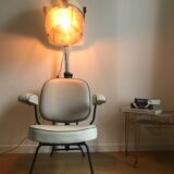 Vintage hairdresser's armchair with helmet transformed into a lamp