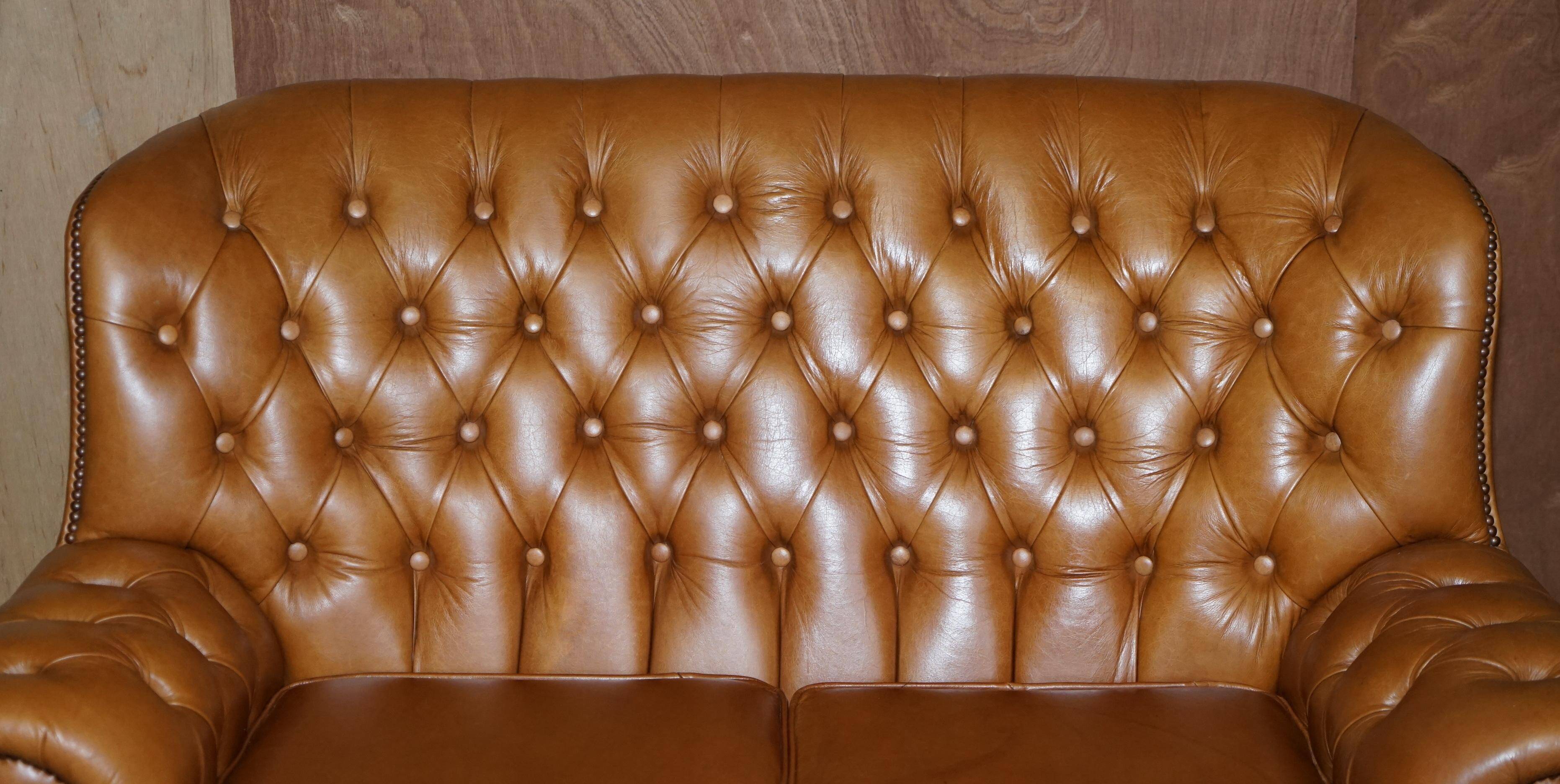 Small Chesterfield leather sofa with a high back.
