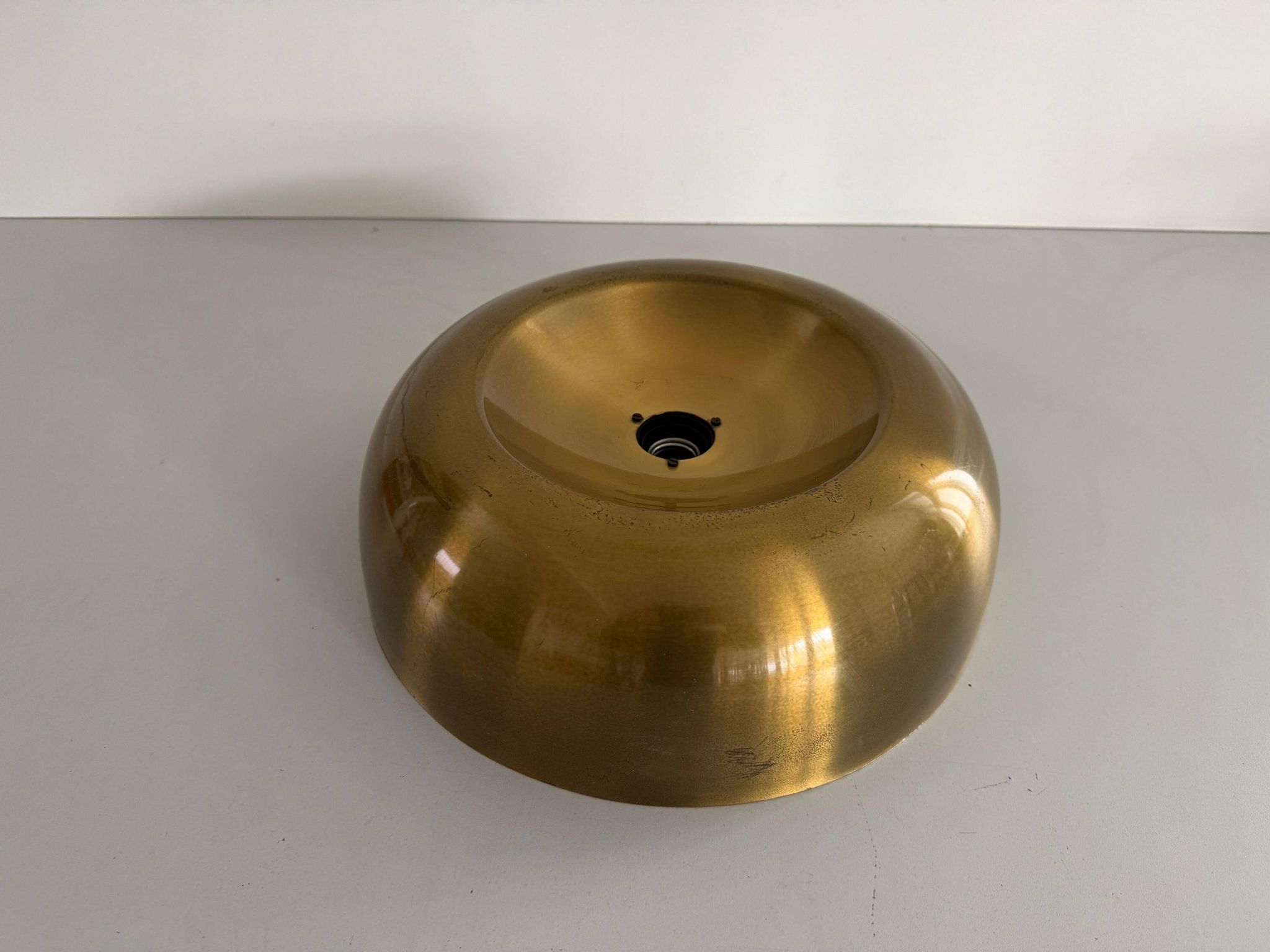 Flush-mounted disc-shaped brass fixture from the mid-century, 1960, Italy.