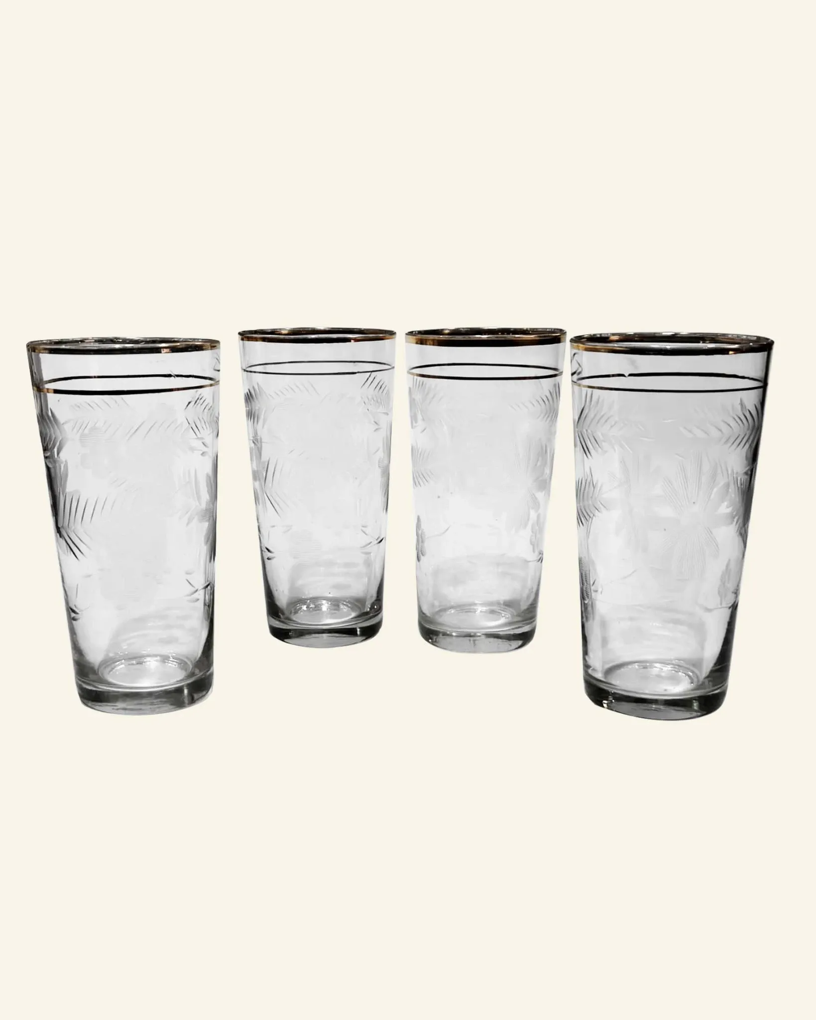 Four engraved crystal glasses from La Granja, with gilded edges, early 20th century.