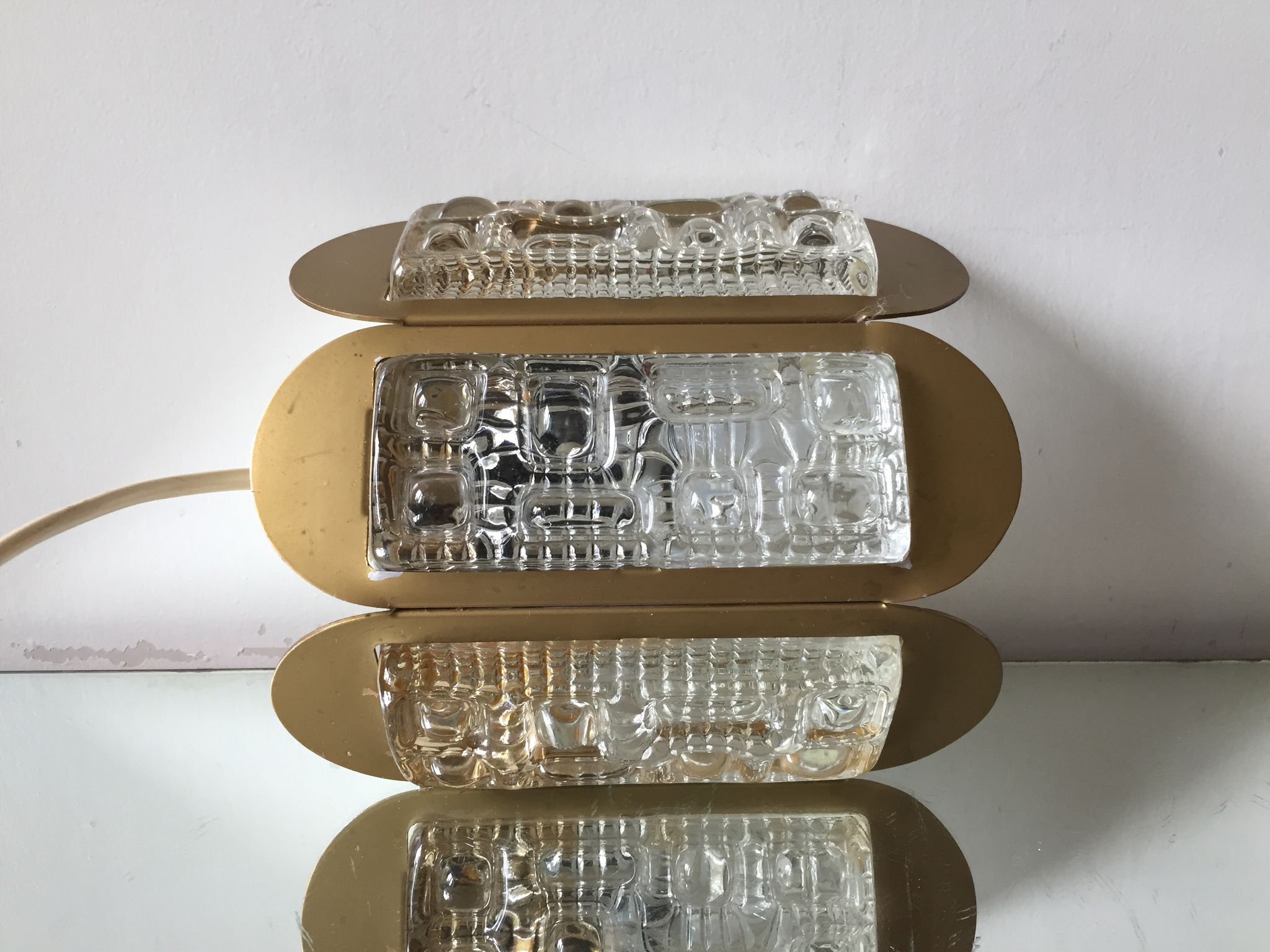 Scandinavian midcentury wall light in crystal and mat gold colored metal