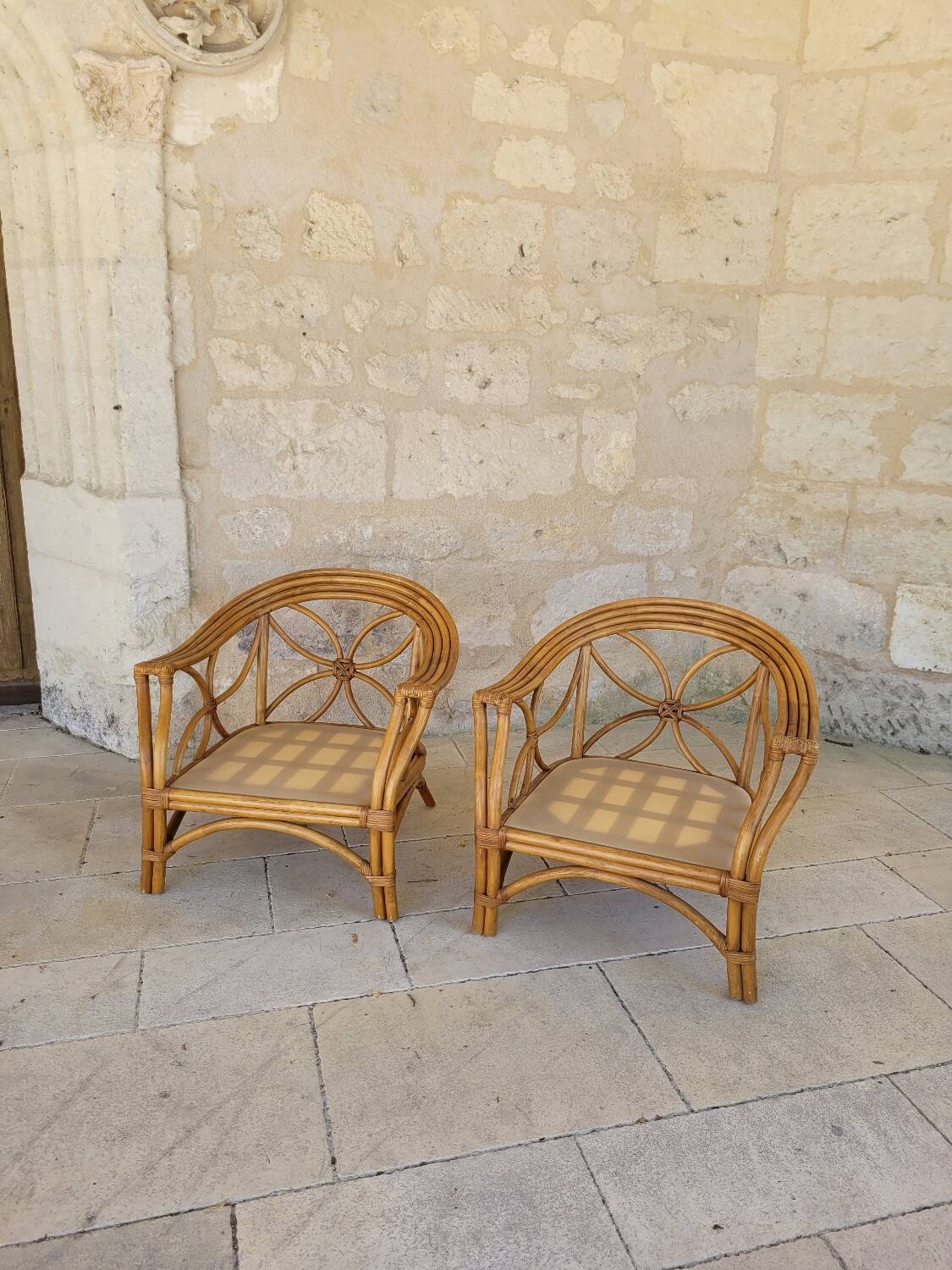 Two large rattan armchairs
