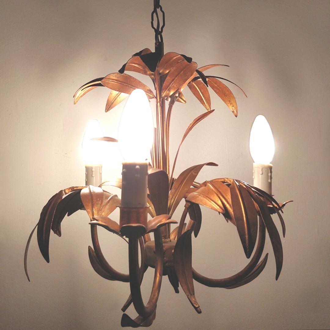 Golden metal chandelier palm leaves