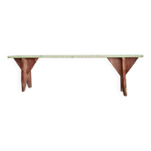 Old wooden farm bench with patinated green seat