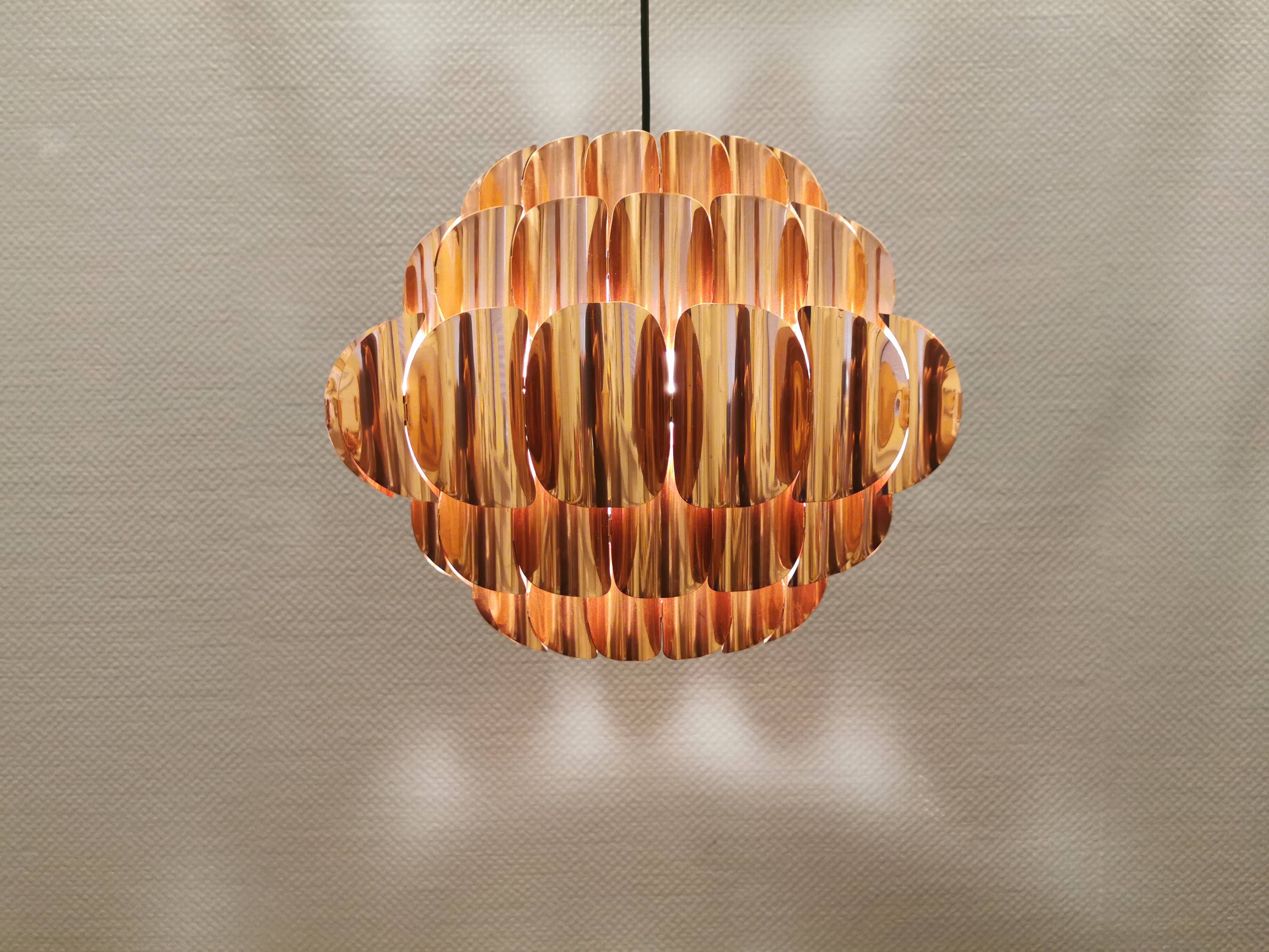 Copper colored hanging lamp. designed by thorsten orrling sweden