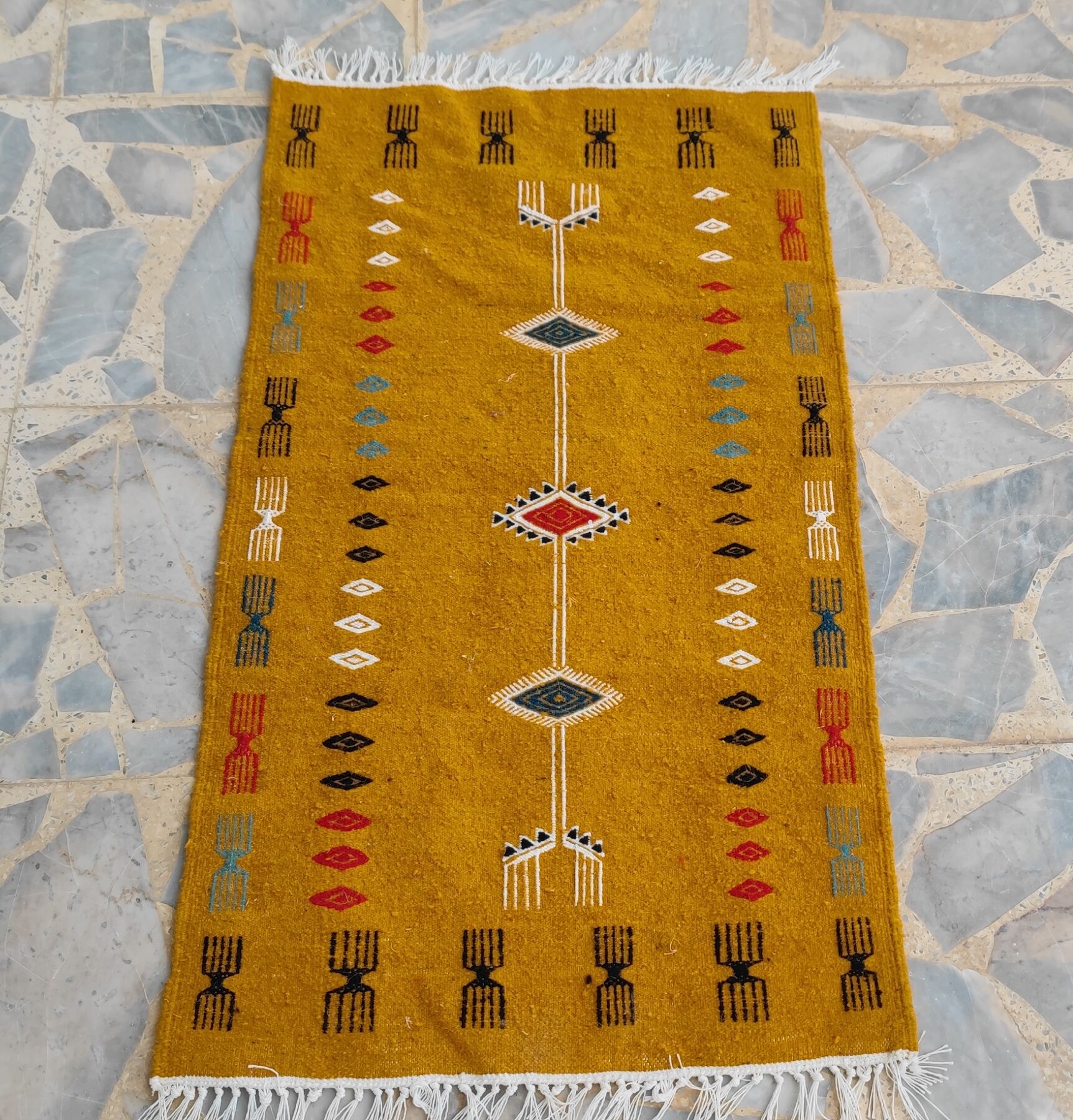 Mustard yellow kilim carpet with multicolored berber patterns