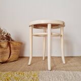 Antique stool with wood and cream caning.
