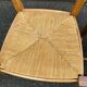 2 solid wood and rush-seated chairs in Louis XV style with shell carving from the 20th century.