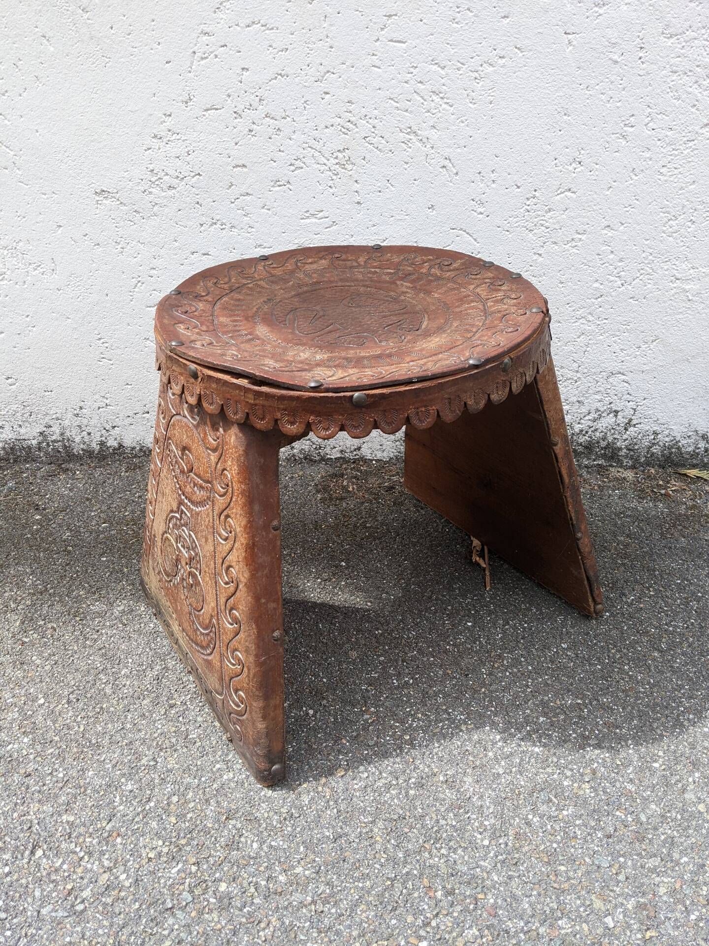 Wood and leather stool, handcrafted African art.
