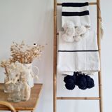 Hand-woven plaid with black stripes and white pompoms