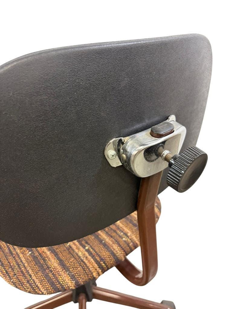 Brown vintage office chair from the 70s on wheels.
