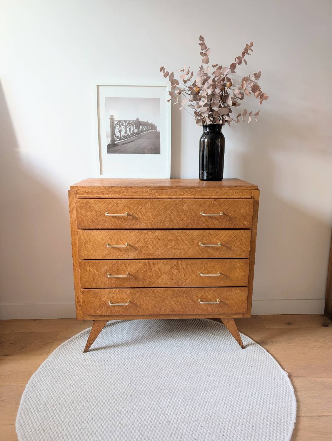 Vintage chest of drawers with checkerboard and compass feet