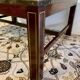 Coffee table in exotic wood, brass trim and planisphere under glass.