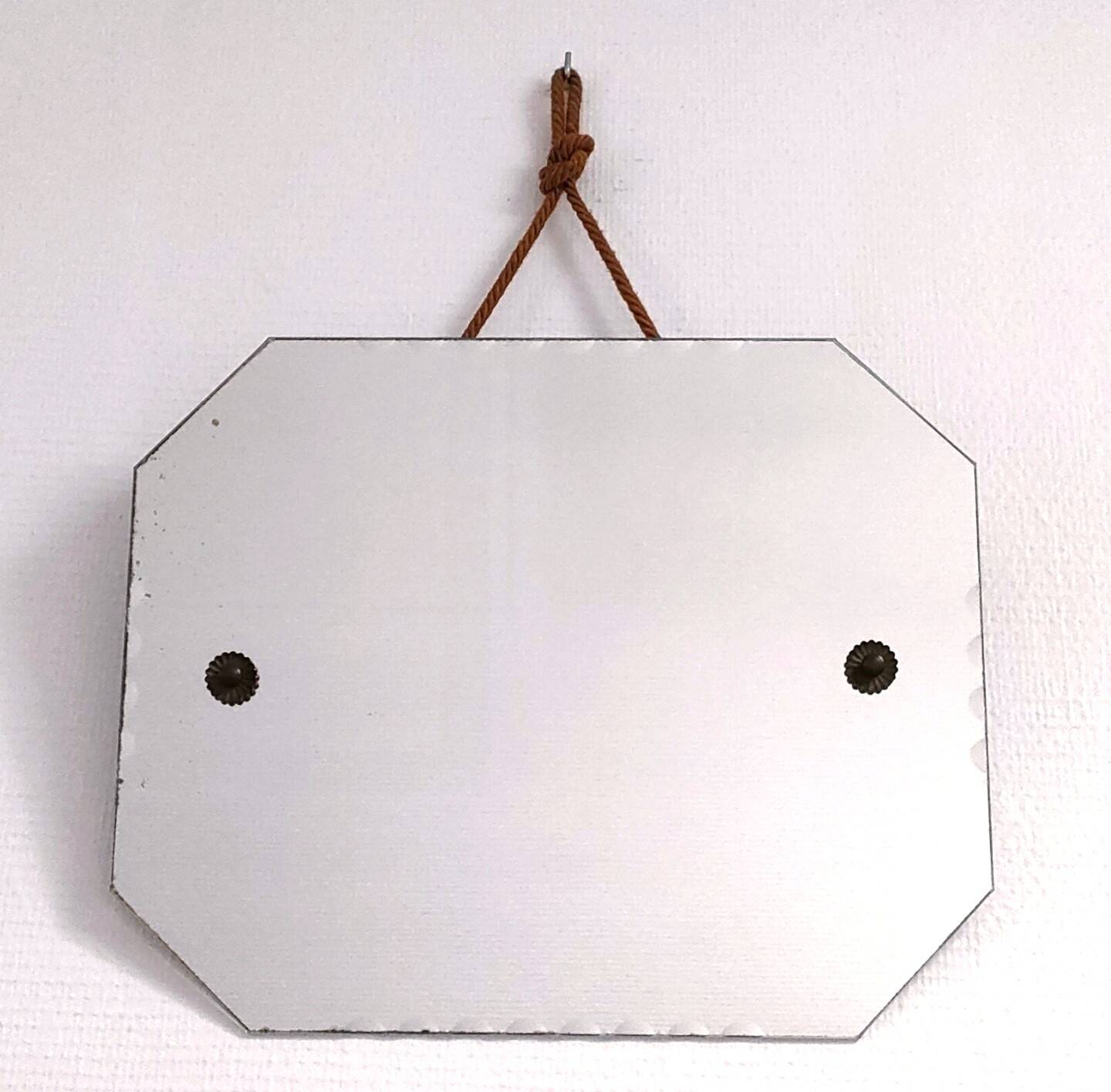Octagonal mirror with brass hubcaps from the 60s