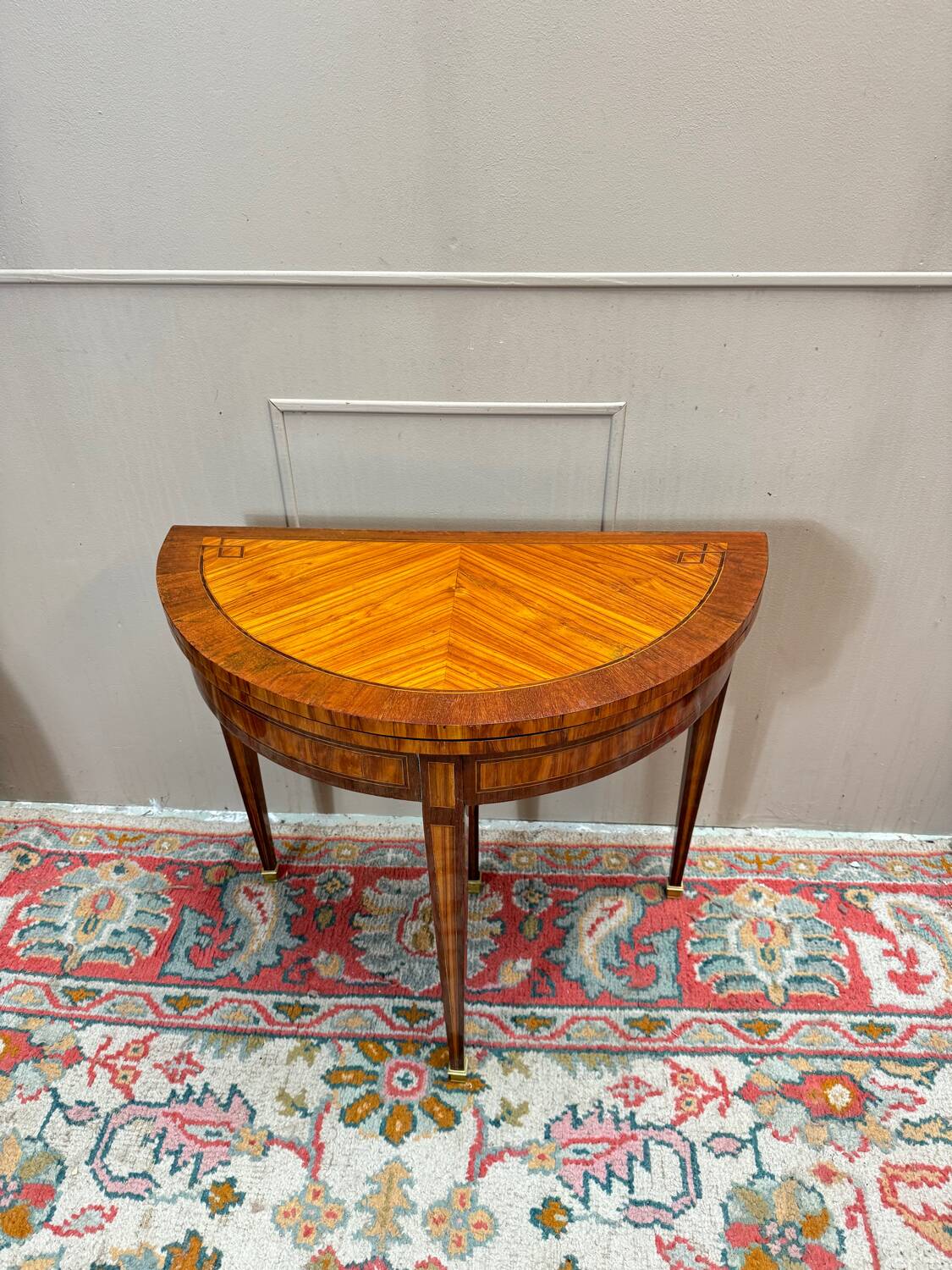 Half-moon game table in marquetry from the Louis XVI period, 18th century.
