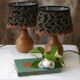 Pair of bedside lamps in pear wood with leopard shade.