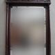 Imposing beveled mirror with wooden frame