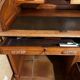Oak desk with sliding door and leather wood chair.
