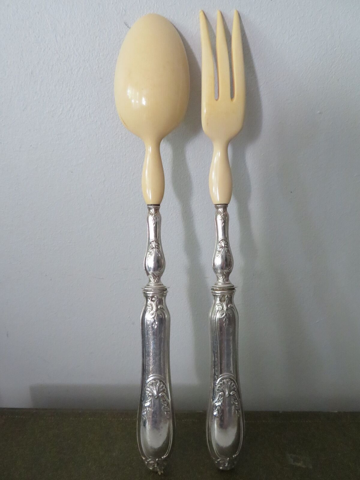 Silver salad servers stuffed in its case