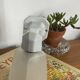 Swan neck wall light in ceramic with a translucent glass globe.