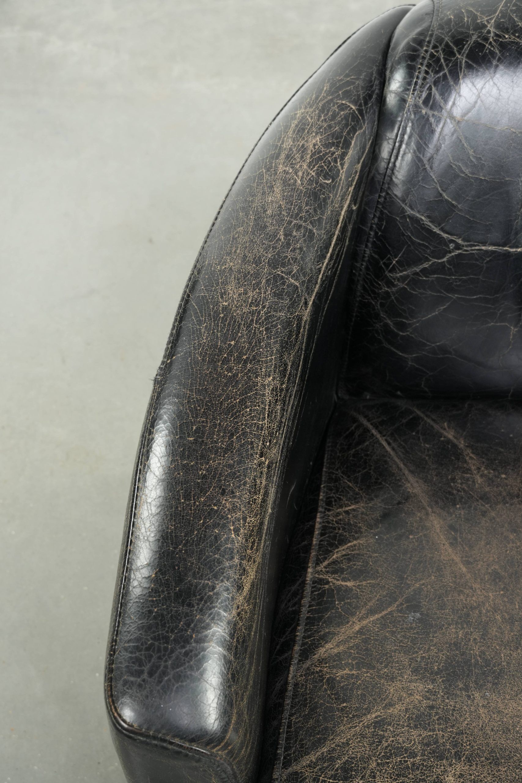 Black vintage cowhide aviator design armchair with characterful appearance