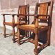 Pair of oak armchairs with straw seats and backs.